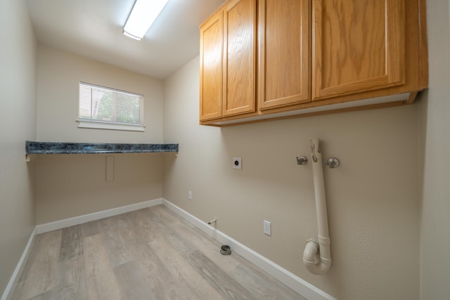 5867 Bell Rd, Redding, CA 96001 - laundry area with cabinet space, electric dryer hookup, light wood-type flooring, and baseboards