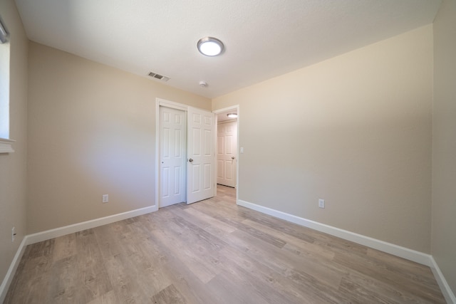 5867 Bell Rd, Redding, CA 96001 - unfurnished bedroom featuring light wood finished floors, baseboards, and a closet