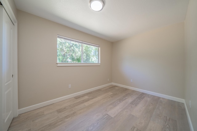 5867 Bell Rd, Redding, CA 96001 - unfurnished bedroom featuring light wood-style flooring, baseboards, and a closet