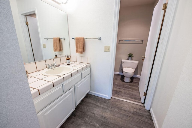 410 Ridgecrest Trl Unit 226, Redding, CA 96003 - bathroom featuring toilet, wood finished floors, vanity, and baseboards