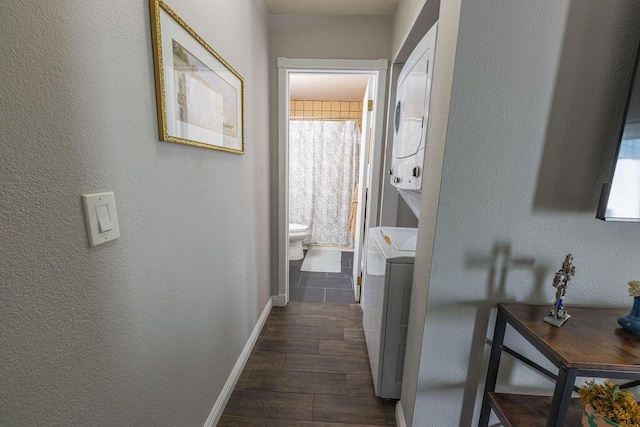 410 Ridgecrest Trl Unit 226, Redding, CA 96003 - hallway featuring stacked washer / dryer, baseboards, a textured wall, and dark wood-style flooring