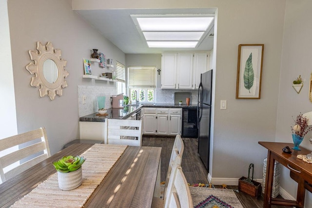 410 Ridgecrest Trl Unit 226, Redding, CA 96003 - kitchen with white cabinetry, dark countertops, dark wood finished floors, freestanding refrigerator, and decorative backsplash