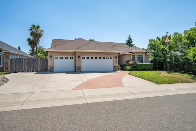 3337 Old Lantern Dr, Redding, CA 96003 - ranch-style home featuring an attached garage, driveway, stucco siding, and stone siding