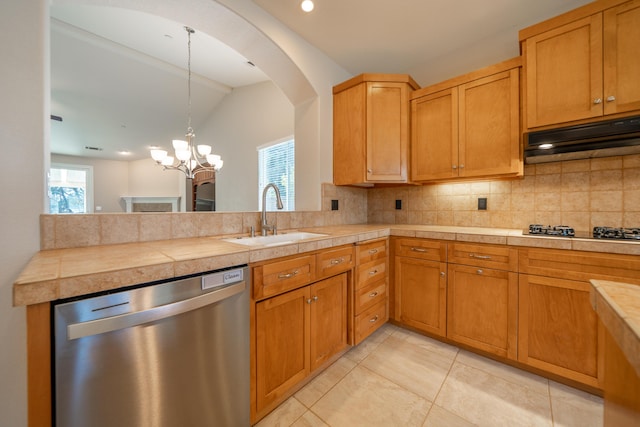3337 Old Lantern Dr, Redding, CA 96003 - kitchen with stainless steel dishwasher, a sink, black gas cooktop, under cabinet range hood, and tasteful backsplash