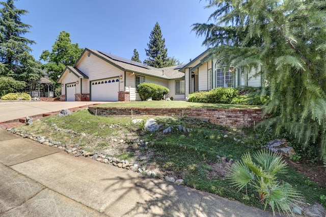 3097 Butterfly Ln, Shasta Lake, CA 96019 - single story home with an attached garage, roof mounted solar panels, and concrete driveway