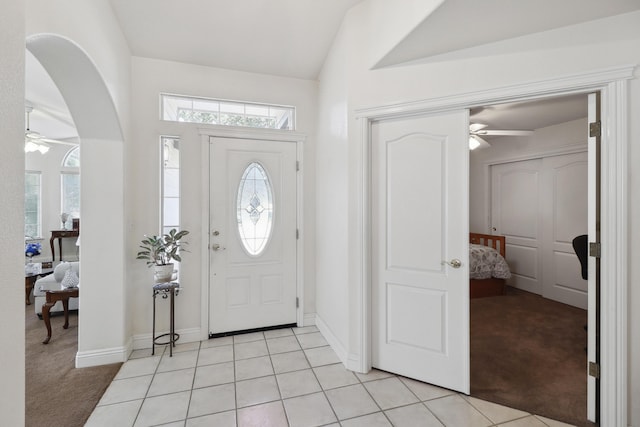 3097 Butterfly Ln, Shasta Lake, CA 96019 - foyer entrance with ceiling fan, arched walkways, light carpet, vaulted ceiling, and baseboards