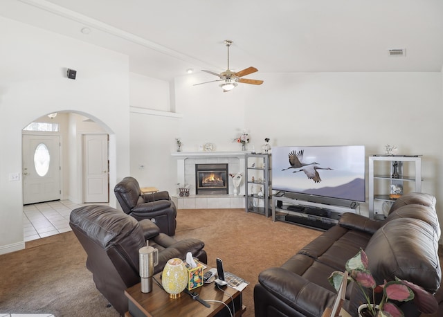 3097 Butterfly Ln, Shasta Lake, CA 96019 - living area with carpet flooring, arched walkways, ceiling fan, a fireplace, and tile patterned floors