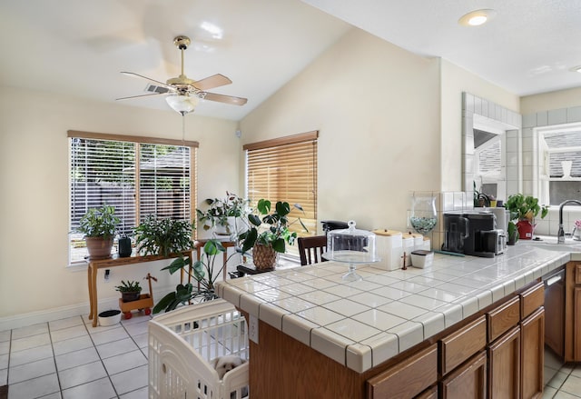 3097 Butterfly Ln, Shasta Lake, CA 96019 - kitchen featuring ceiling fan, brown cabinetry, light tile patterned flooring, tile counters, and dishwashing machine
