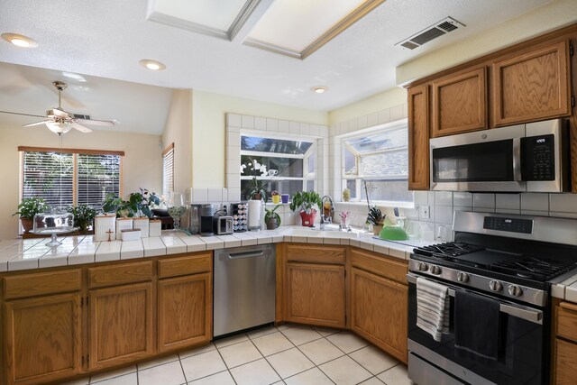 3097 Butterfly Ln, Shasta Lake, CA 96019 - kitchen featuring appliances with stainless steel finishes, a sink, ceiling fan, brown cabinetry, and recessed lighting