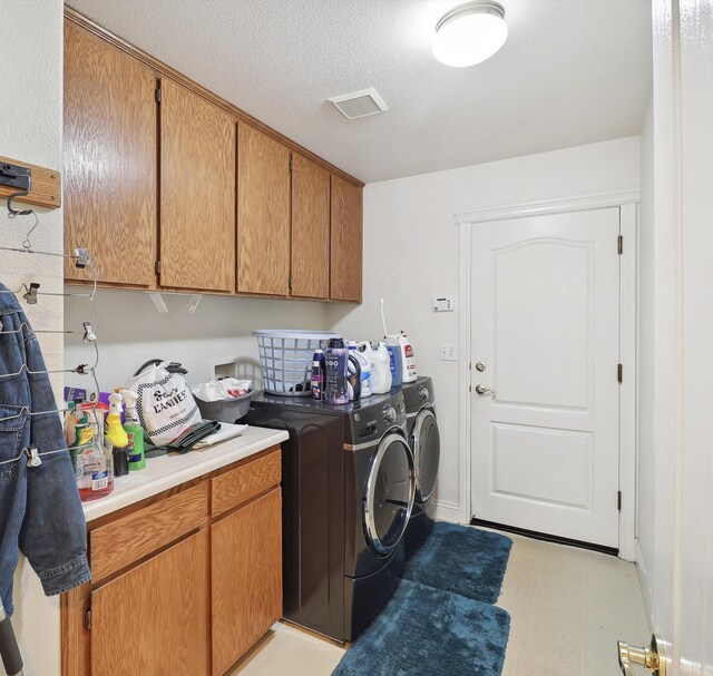 3097 Butterfly Ln, Shasta Lake, CA 96019 - washroom featuring washer and clothes dryer, cabinet space, and light flooring