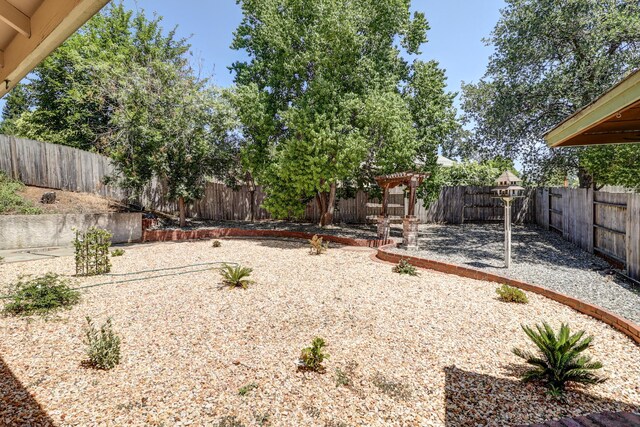 3097 Butterfly Ln, Shasta Lake, CA 96019 - fenced backyard with a patio and a pergola
