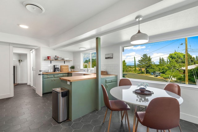 2180 Oak Ridge Dr, Redding, CA 96001 - kitchen with butcher block countertops, green cabinetry, pendant lighting, a peninsula, and recessed lighting