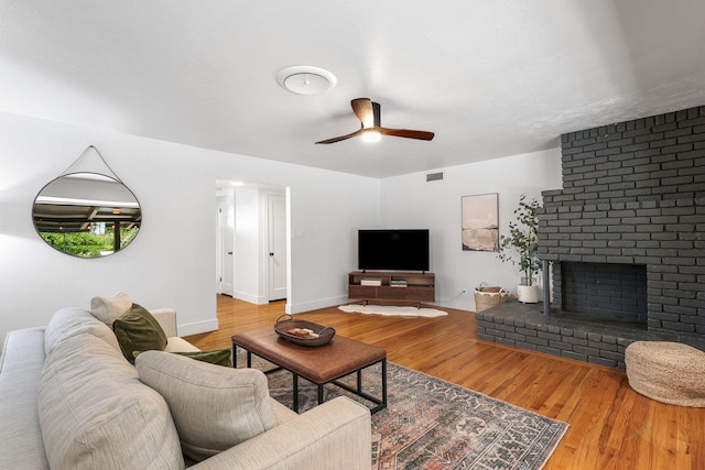2180 Oak Ridge Dr, Redding, CA 96001 - living room with a ceiling fan, wood finished floors, and a brick fireplace