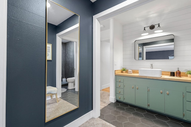 2180 Oak Ridge Dr, Redding, CA 96001 - bathroom featuring vanity, tile patterned flooring, and wooden walls