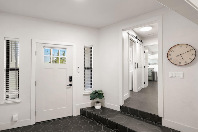 2180 Oak Ridge Dr, Redding, CA 96001 - foyer featuring a barn door and dark tile patterned flooring