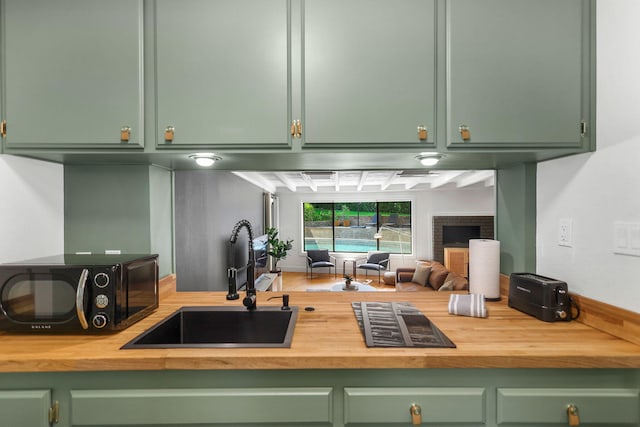 2180 Oak Ridge Dr, Redding, CA 96001 - kitchen featuring green cabinetry, black microwave, wood counters, and open floor plan