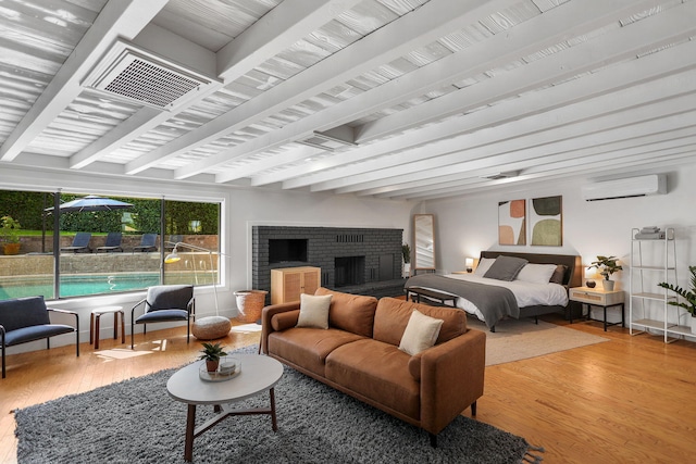 2180 Oak Ridge Dr, Redding, CA 96001 - bedroom with beamed ceiling, an AC wall unit, wood finished floors, and a fireplace