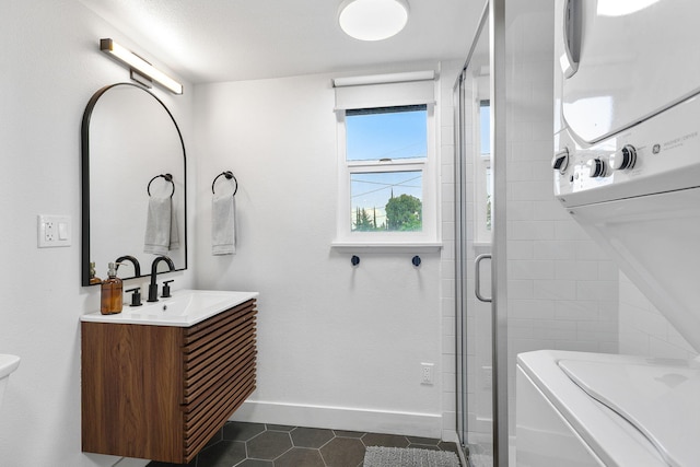 2180 Oak Ridge Dr, Redding, CA 96001 - bathroom with estacked washer and dryer, tile patterned flooring, a shower stall, and vanity