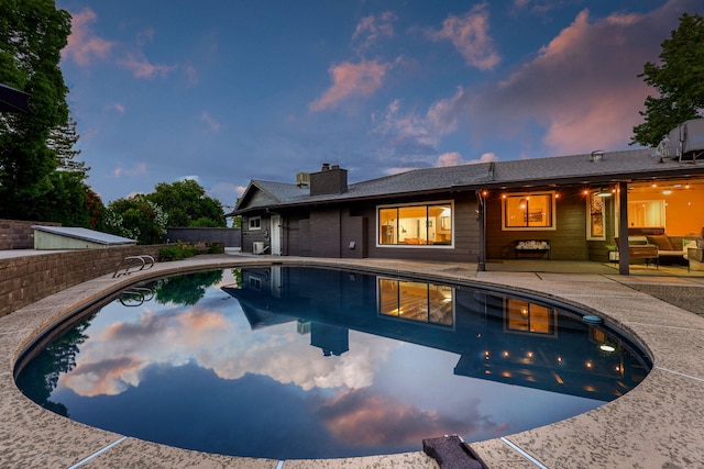 2180 Oak Ridge Dr, Redding, CA 96001 - pool at dusk with a patio and an outdoor hangout area