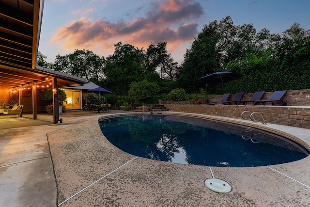 2180 Oak Ridge Dr, Redding, CA 96001 - pool at dusk with a patio area and an outdoor pool