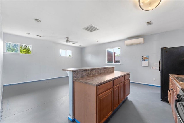 2025 El Verano St, Redding, CA 96002 - kitchen with a wall mounted air conditioner, brown cabinetry, finished concrete floors, freestanding refrigerator, and ceiling fan