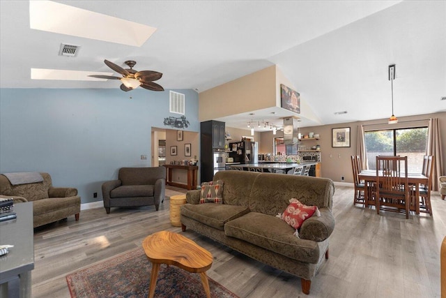 2025 El Verano St, Redding, CA 96002 - living area with light wood-style flooring, baseboards, ceiling fan, high vaulted ceiling, and a chandelier