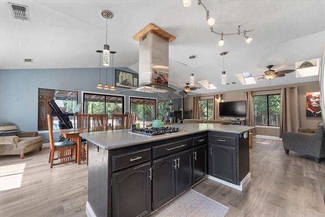 2025 El Verano St, Redding, CA 96002 - kitchen featuring open floor plan, a ceiling fan, stainless steel gas cooktop, light wood-style flooring, and a skylight