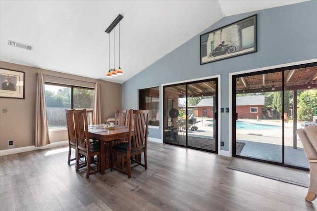 2025 El Verano St, Redding, CA 96002 - dining space with wood finished floors, baseboards, and high vaulted ceiling