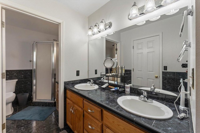 2025 El Verano St, Redding, CA 96002 - full bath featuring toilet, a stall shower, double vanity, tile walls, and marble finish floors