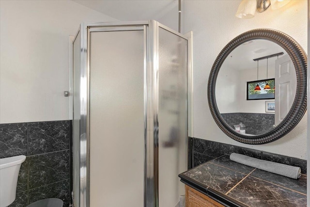 2025 El Verano St, Redding, CA 96002 - bathroom with toilet, a shower stall, vanity, and tile walls