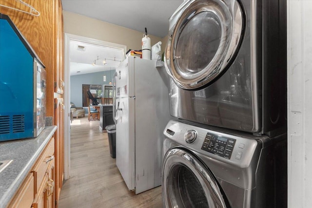 2025 El Verano St, Redding, CA 96002 - washroom featuring stacked washer / drying machine and light wood finished floors