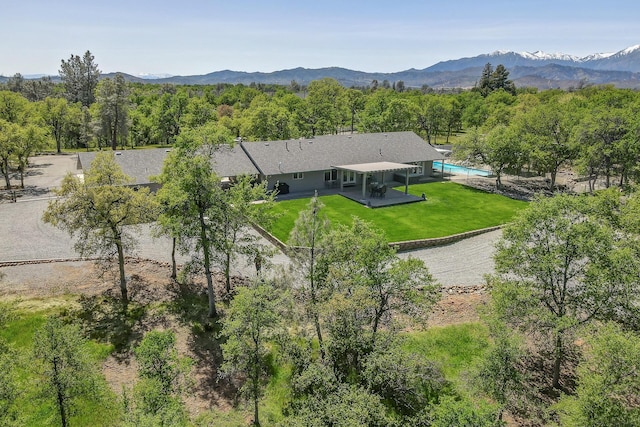 17400 Pittim Dr, Redding, CA 96003 - view from above of property with a mountain backdrop and a heavily wooded area