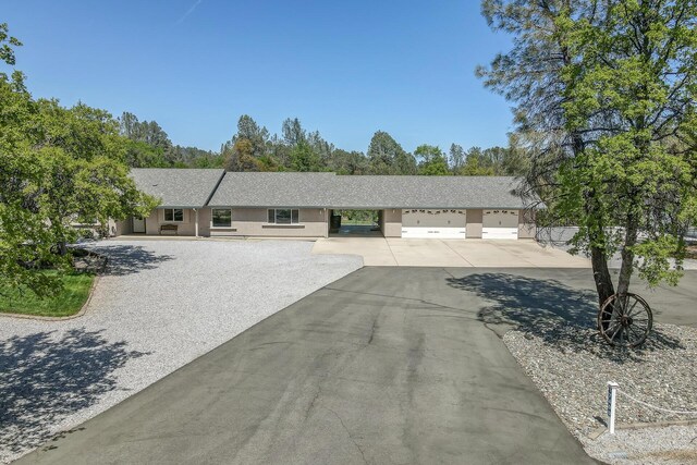 17400 Pittim Dr, Redding, CA 96003 - single story home featuring asphalt driveway, an attached garage, and stucco siding