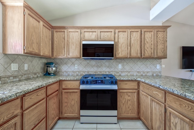17400 Pittim Dr, Redding, CA 96003 - kitchen featuring range with gas cooktop, lofted ceiling, backsplash, light tile patterned flooring, and light stone countertops
