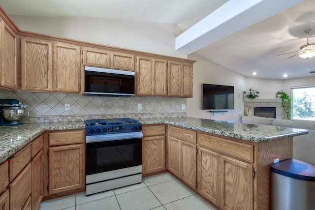 17400 Pittim Dr, Redding, CA 96003 - kitchen with gas range, decorative backsplash, a peninsula, a ceiling fan, and light tile patterned flooring