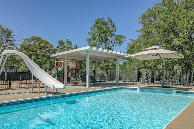 17400 Pittim Dr, Redding, CA 96003 - view of swimming pool featuring a water slide and a playground