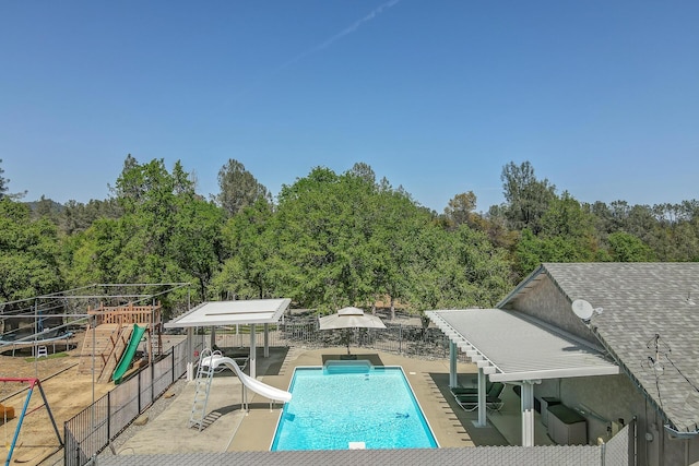 17400 Pittim Dr, Redding, CA 96003 - view of pool with a water slide, a patio, and a wooded view