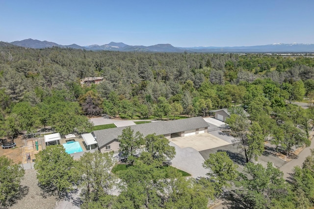 17400 Pittim Dr, Redding, CA 96003 - aerial view of a forest, a pool, and a mountain backdrop