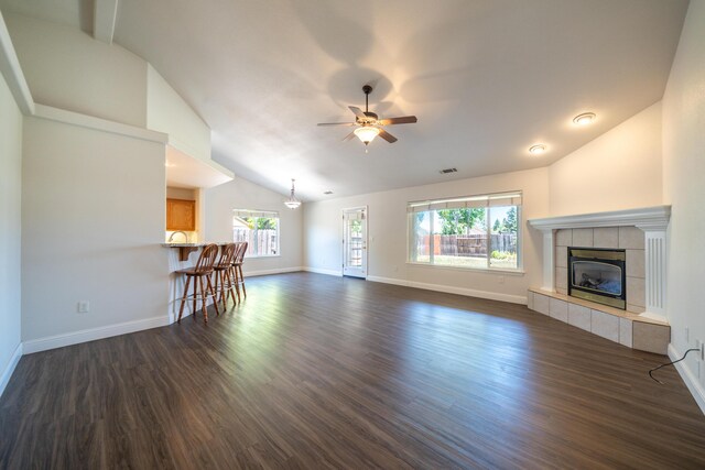 3255 Wandsworth Dr, Shasta Lake, CA 96019 - unfurnished living room featuring lofted ceiling, a ceiling fan, dark wood-style floors, and a tiled fireplace