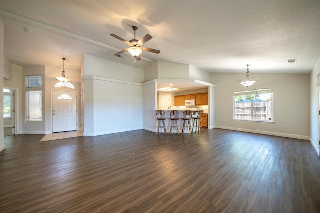 3255 Wandsworth Dr, Shasta Lake, CA 96019 - unfurnished living room with vaulted ceiling, ceiling fan, and dark wood finished floors