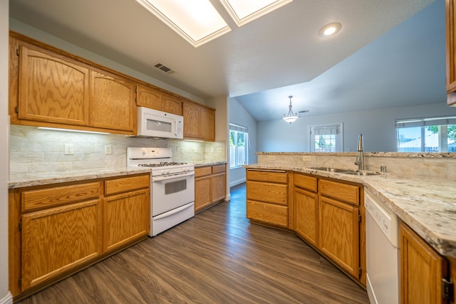 3255 Wandsworth Dr, Shasta Lake, CA 96019 - kitchen with white appliances, vaulted ceiling, dark wood finished floors, tasteful backsplash, and a skylight