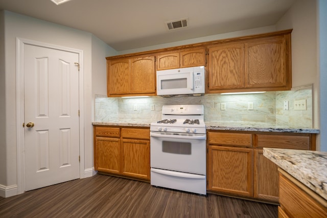 3255 Wandsworth Dr, Shasta Lake, CA 96019 - kitchen featuring white appliances, dark wood-type flooring, backsplash, and brown cabinetry