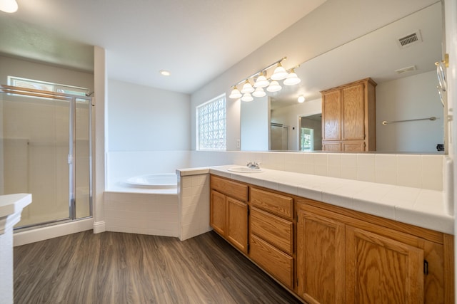 3255 Wandsworth Dr, Shasta Lake, CA 96019 - full bathroom with wood finished floors, a garden tub, vanity, and a shower stall
