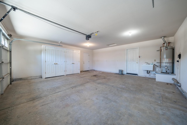 3255 Wandsworth Dr, Shasta Lake, CA 96019 - garage featuring strapped water heater and a sink