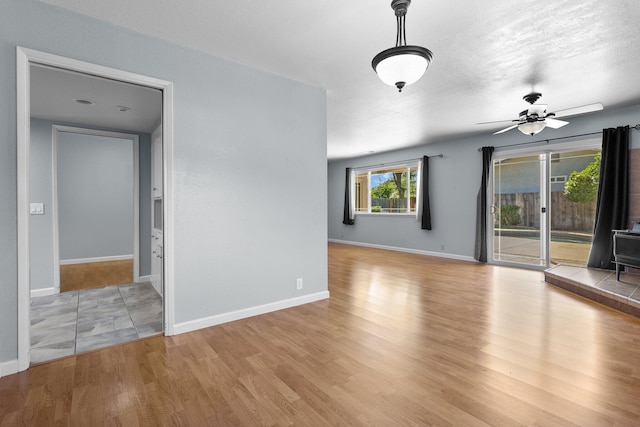 1401 Casa Vereda Way, Redding, CA 96003 - spare room featuring a wood stove, light wood finished floors, and a ceiling fan