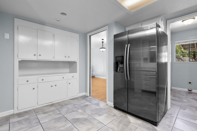 1401 Casa Vereda Way, Redding, CA 96003 - kitchen featuring stainless steel fridge, white cabinets, and light countertops