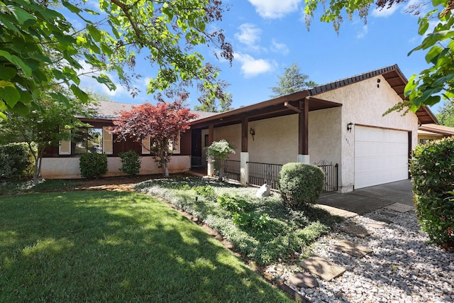 1401 Casa Vereda Way, Redding, CA 96003 - view of front of property featuring a garage, stucco siding, a front lawn, and asphalt driveway