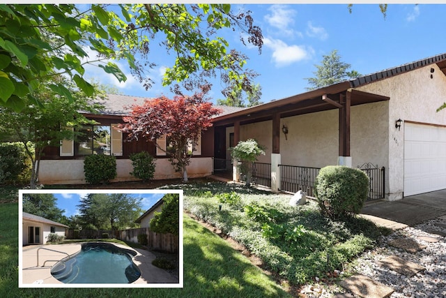 1401 Casa Vereda Way, Redding, CA 96003 - back of property with stucco siding and a garage