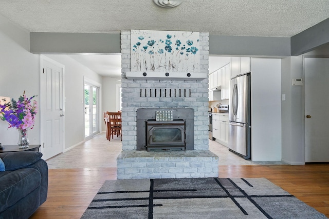 2034 Wilder Dr, Redding, CA 96002 - living area featuring light wood-type flooring, baseboards, and a textured ceiling