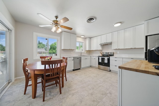 2034 Wilder Dr, Redding, CA 96002 - kitchen featuring appliances with stainless steel finishes, under cabinet range hood, a sink, butcher block counters, and a ceiling fan